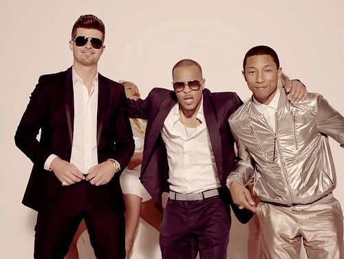 "Blurred Lines" is all male fantasy with fully clothed men being surrounded by undressed or barely dressed women. The men seem more connected to each other than to the women around them. (Photo courtesy Interscope)